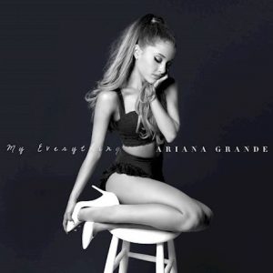 Ariana Grande sitting on a white stool